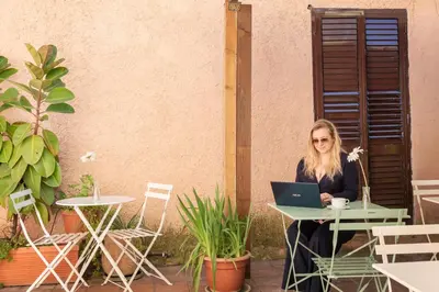 a woman sitting at a table with a laptop at Hotel Parker - Gruppo BLAM HOTELS in Rome