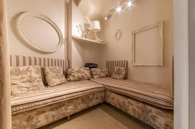 a bed in a room with a mirror on the wall at Nina Casetta De Trastevere in Rome