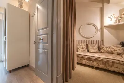 a room with a bench and a mirror and a door at Nina Casetta De Trastevere in Rome