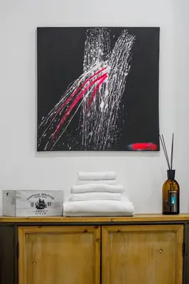 a painting on a wall above a wooden cabinet at Crossroad Hotel in Rome