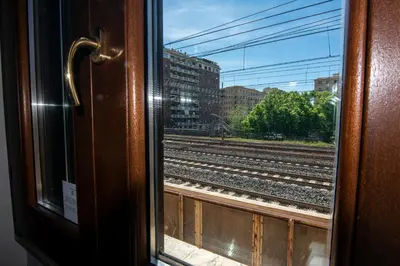 a view of train tracks from a train window at Crossroad Hotel in Rome