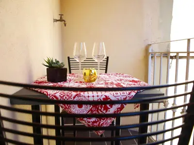 a table with two wine glasses on top of it at Casa Tua a Piazza del Popolo in Rome