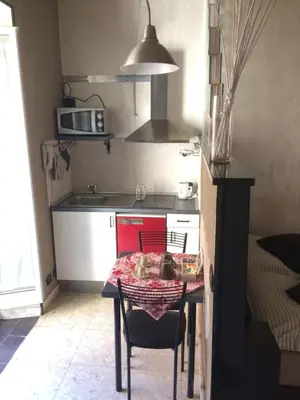 a small kitchen with a table and a table and chairs at Casa Tua a Piazza del Popolo in Rome
