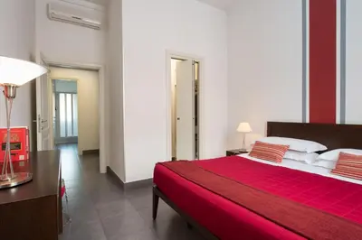 a bedroom with a large bed with a red blanket at Residenza Termini in Rome