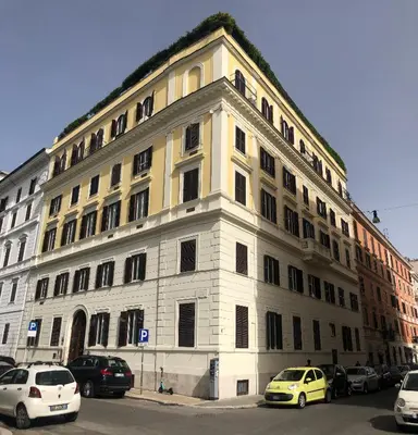 a large white building with cars parked in front of it at Residenza Termini in Rome