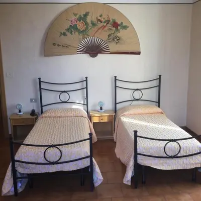two beds sitting next to each other in a room at Hotel Touring in Rome