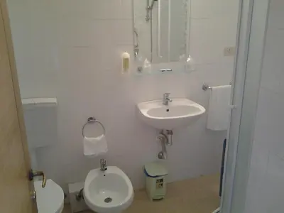 a bathroom with a toilet and a sink at Hotel Touring in Rome