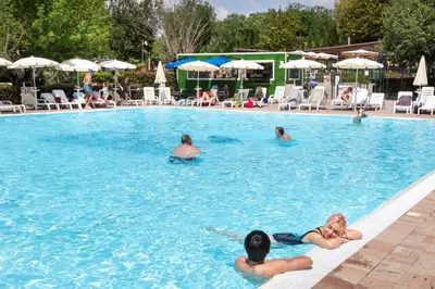 a group of people swimming in a swimming pool at hu Roma Camping In Town in Rome