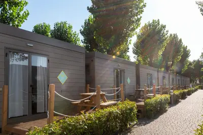 a row of tables and benches next to a building at hu Roma Camping In Town in Rome