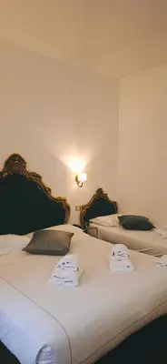 two beds sitting next to each other in a bedroom at DCBoutiqueHotel in Rome