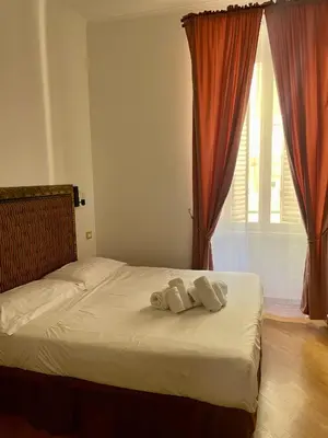 a bedroom with a bed with two towels on it at DCBoutiqueHotel in Rome