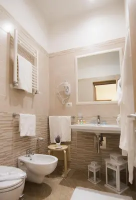 a bathroom with a sink and a toilet and a mirror at Esposizione Palace Hotel in Rome