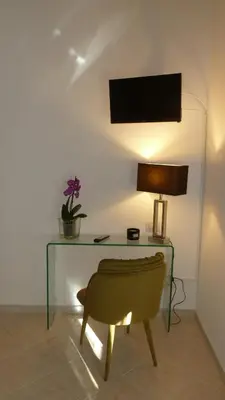 a desk with a chair and a lamp and a plant at Camera Con Vista in Rome