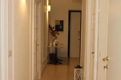 a hallway with a table in the middle of a room at Camera Con Vista in Rome