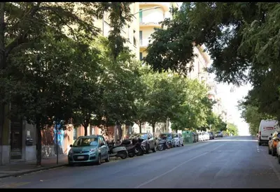 a street with cars parked on the side of the road at Camera Con Vista in Rome