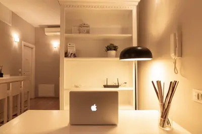 a laptop computer sitting on top of a table at TrastevereInn in Rome