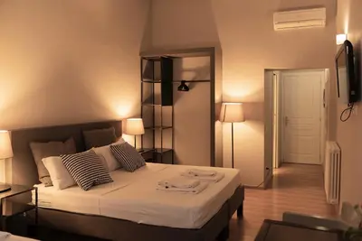 a bedroom with a large bed with two lamps at TrastevereInn in Rome