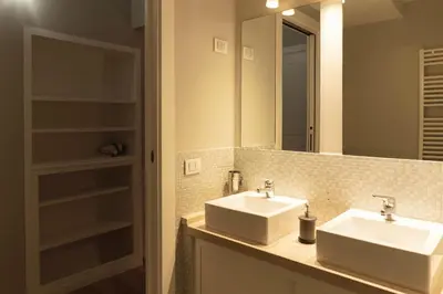 a bathroom with two sinks and a mirror at TrastevereInn in Rome