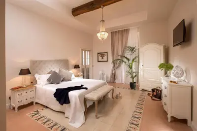 a bedroom with a large white bed and a tv at Trevi Ab Aeterno - Amazing View of the Trevi Fountain in Rome