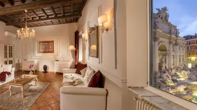 a living room with a large painting on the wall at Trevi Ab Aeterno - Amazing View of the Trevi Fountain in Rome