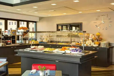 a buffet line with food on display in a restaurant at iQ Hotel Roma in Rome