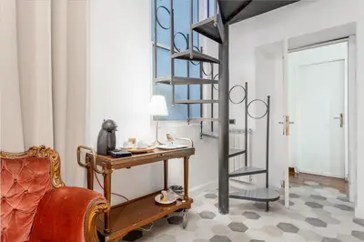a room with a desk and a spiral staircase at Palazzo Del Duca Piazza Navona Campo dei Fiori Piazza del Fico Guest House in Rome