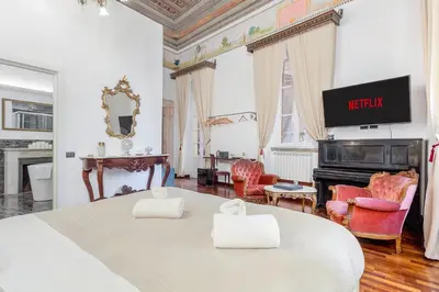a large bedroom with a bed and a tv on the wall at Palazzo Del Duca Piazza Navona Campo dei Fiori Piazza del Fico Guest House in Rome