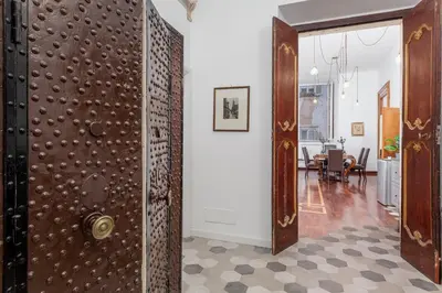 a hallway with a door and a dining room at Palazzo Del Duca Piazza Navona Campo dei Fiori Piazza del Fico Guest House in Rome