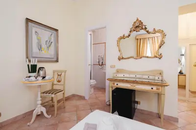 a bathroom with a table and a mirror on the wall at Sourire Hotel in Rome