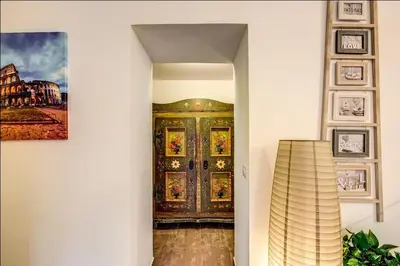 a hallway with a door with a painting on the wall at Cuore di Florio Apartment in Rome