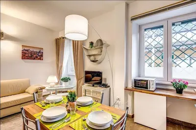 a living room with a table and chairs and a couch at Cuore di Florio Apartment in Rome