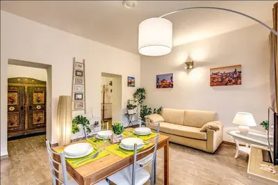 a living room with a table and a couch at Cuore di Florio Apartment in Rome