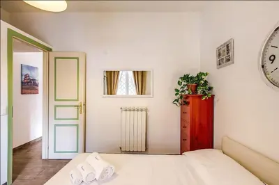 a bedroom with a bed and a clock on the wall at Cuore di Florio Apartment in Rome