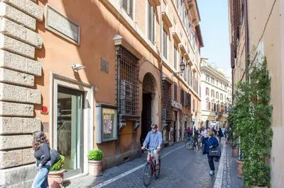 a group of people riding bikes down a street at Campo Marzio Exclusive Maison in Rome