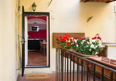 a balcony with red and white flowers on it at Campo Marzio Exclusive Maison in Rome