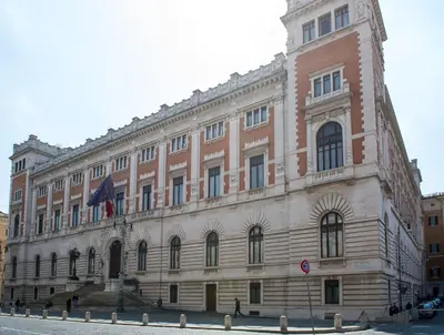 a large building with a flag in front of it at Campo Marzio Exclusive Maison in Rome