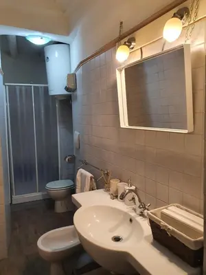 a bathroom with a sink and a toilet and a mirror at Campo Marzio Exclusive Maison in Rome