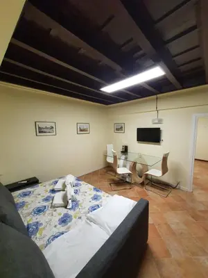 a bedroom with a bed and a table and chairs at Campo Marzio Exclusive Maison in Rome