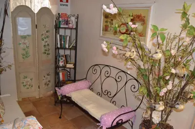 a hallway with a table and a vase of flowers at Bye Rome Guesthouse in Rome