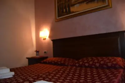 a hotel room with a bed with towels on it at Bye Rome Guesthouse in Rome