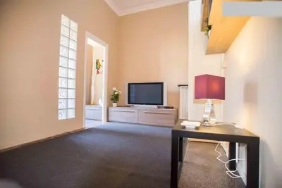 a bedroom with a white bed in a room at Happy House Rienzo in Rome