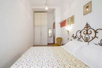 a bedroom with a large bed with a floral bedspread at Trastevere classico self check in in Rome
