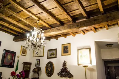a room with a chandelier and pictures on the wall at B&B Domus Piazza del Popolo in Rome