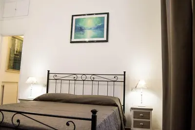 a bedroom with a bed and a picture on the wall at B&B Domus Piazza del Popolo in Rome