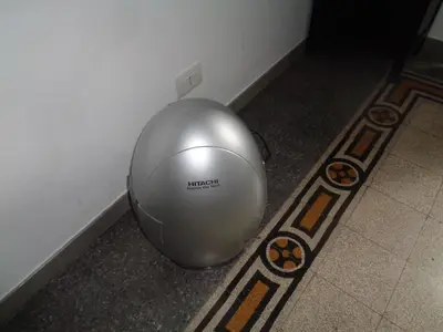 a silver ball sitting on the floor next to a wall at T C RMs in Rome
