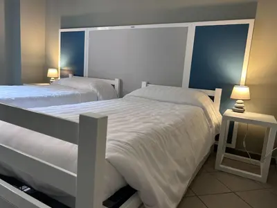 a bedroom with two beds and a lamp on a table at Roma Scout Center in Rome