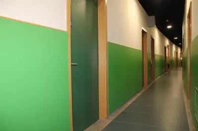 a hallway with green and white walls and a long corridor at Roma Scout Center in Rome