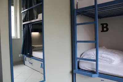 two bunk beds in a room with a bed at Roma Scout Center in Rome