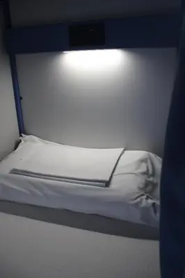 a small bed with a light on top of it at Roma Scout Center in Rome