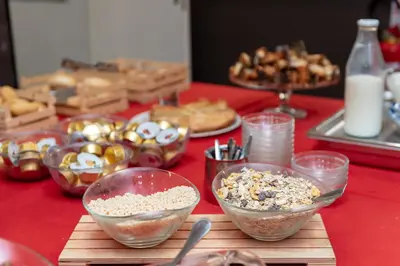 a table with bowls of food on a red table at Roma Scout Center in Rome